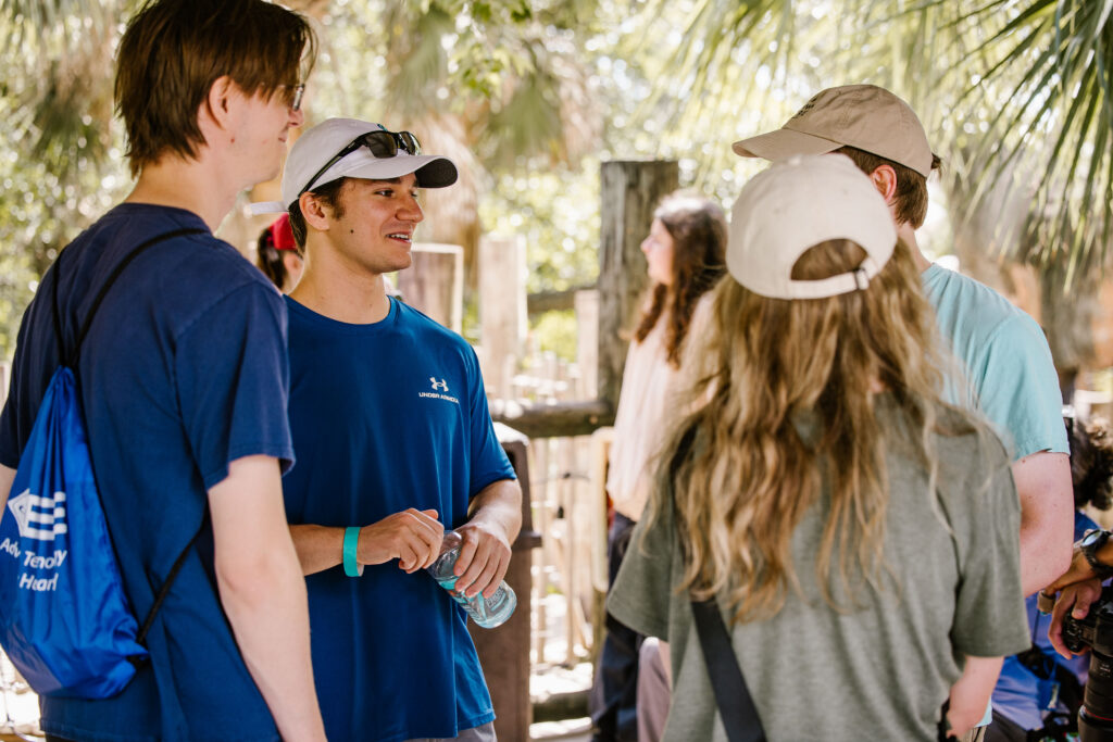 Young adults engage in conversation outdoors, showcasing a vibrant social atmosphere at STR.